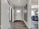 Inviting foyer with wood flooring, sliding barn door, and views into the main living space at 20147 Chad Hittle Blvd, Westfield, IN 46074