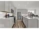Modern kitchen featuring gray cabinets, stainless steel appliances, and a white subway tile backsplash at 20147 Chad Hittle Blvd, Westfield, IN 46074