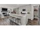 Open concept kitchen with a large island, seating, and view to a fireplace at 20147 Chad Hittle Blvd, Westfield, IN 46074