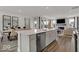 Modern kitchen with stainless steel dishwasher in island overlooking living and dining areas at 20147 Chad Hittle Blvd, Westfield, IN 46074