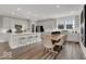 Open kitchen with a central island, bar seating, and ample white cabinetry for storage at 20147 Chad Hittle Blvd, Westfield, IN 46074