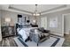 Calming main bedroom featuring neutral tones, a stylish chandelier, and a comfortable sitting area at 20147 Chad Hittle Blvd, Westfield, IN 46074