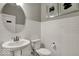Stylish powder room with a pedestal sink, round mirror, and tiled walls at 20147 Chad Hittle Blvd, Westfield, IN 46074