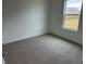 A bright bedroom featuring neutral carpet, fresh white paint, and a window with exterior views at 2109 Boxwood Dr, Greenfield, IN 46140