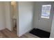 Bright entryway with wood-look flooring and half bathroom access and a front door window to view the exterior at 2109 Boxwood Dr, Greenfield, IN 46140
