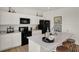 Contemporary kitchen featuring white cabinets, a large island, and sleek black appliances at 2109 Boxwood Dr, Greenfield, IN 46140