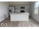 Modern kitchen with white cabinets, a center island, and stainless steel appliances at 2109 Boxwood Dr, Greenfield, IN 46140