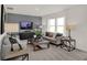 Comfortable living room features a gray accent wall, modern furniture, and large windows for natural light at 2109 Boxwood Dr, Greenfield, IN 46140