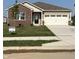 Charming single-story home with brick and vinyl siding, a well-manicured lawn, and an attached two-car garage at 2152 Foothill Dr, Greenfield, IN 46140