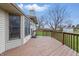 A spacious wooden back deck provides ample outdoor living space with views of the landscaped backyard at 2231 Reston Ln, Columbus, IN 47203
