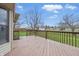 A spacious wooden back deck provides ample outdoor living space with views of the landscaped backyard at 2231 Reston Ln, Columbus, IN 47203