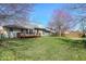 The level backyard features a wooden deck, mature trees, and plenty of space for outdoor activities at 2231 Reston Ln, Columbus, IN 47203