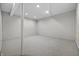 Basement area features exposed support beams and carpeted floors at 2231 Reston Ln, Columbus, IN 47203