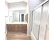 Bathroom boasts dual sinks, and shower and tub with sliding glass door at 2231 Reston Ln, Columbus, IN 47203