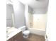 Bathroom with a shower/tub combo, sink with wooden cabinet, and tile flooring at 2231 Reston Ln, Columbus, IN 47203
