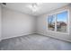 Carpeted bedroom with a ceiling fan and view to the outdoors at 2231 Reston Ln, Columbus, IN 47203