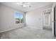 Bright bedroom features neutral walls, carpet, ceiling fan, and large window offering natural light at 2231 Reston Ln, Columbus, IN 47203