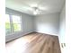 Bedroom featuring vinyl floors, ceiling fan, and a large window letting in natural light at 2231 Reston Ln, Columbus, IN 47203