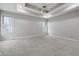 Large bedroom featuring tray ceiling, ceiling fan and natural light at 2231 Reston Ln, Columbus, IN 47203