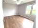 Bedroom featuring vinyl floors, ceiling fan, and a large window letting in natural light at 2231 Reston Ln, Columbus, IN 47203