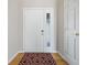 Welcoming foyer featuring hardwood floors, a stylish area rug, and a bright white front door at 2231 Reston Ln, Columbus, IN 47203