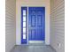 Stylish blue front door with sidelight and modern hardware, creating an inviting entrance to the home at 2231 Reston Ln, Columbus, IN 47203