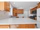 Modern kitchen featuring stainless steel appliances, wooden cabinets, and stone countertops at 2231 Reston Ln, Columbus, IN 47203