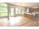 Cozy kitchen with wood cabinetry, island, and adjacent dining area bathed in natural light at 2231 Reston Ln, Columbus, IN 47203