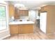 Functional kitchen with ample cabinetry, white countertops, and wood-look flooring at 2231 Reston Ln, Columbus, IN 47203
