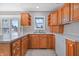 Kitchen featuring wooden cabinets, laminate countertops, and stainless steel sink at 2231 Reston Ln, Columbus, IN 47203