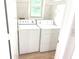 Practical laundry room with washer, dryer, and storage shelves at 2231 Reston Ln, Columbus, IN 47203