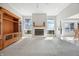 Bright living room with neutral carpet, a cozy fireplace, and a wooden entertainment center at 2231 Reston Ln, Columbus, IN 47203