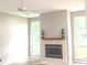 Bright living room featuring a fireplace, ceiling fan, and large windows at 2231 Reston Ln, Columbus, IN 47203
