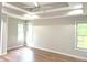 Bright main bedroom features tray ceiling, ceiling fan and natural light at 2231 Reston Ln, Columbus, IN 47203