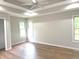Large main bedroom features tray ceiling, ceiling fan and two windows at 2231 Reston Ln, Columbus, IN 47203