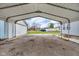 Wide carport offering sheltered parking with a view of the backyard and surrounding properties at 2305 S Rybolt Ave, Indianapolis, IN 46241