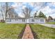 Charming single-story home with a brick walkway leading to the front door and a manicured lawn at 2305 S Rybolt Ave, Indianapolis, IN 46241