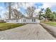 Cozy single-story home with a long gravel driveway and a well-maintained lawn at 2305 S Rybolt Ave, Indianapolis, IN 46241