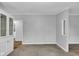 Open concept room features carpet, neutral gray paint, white trim, built in hutch, and doorway views into other rooms at 2305 S Rybolt Ave, Indianapolis, IN 46241