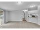Open concept living room, showcases neutral paint, carpet, and access to a fenced backyard through sliding glass doors at 2305 S Rybolt Ave, Indianapolis, IN 46241