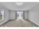 Neutral living room, showcases natural light with large windows and access to outdoor deck through sliding glass doors at 2305 S Rybolt Ave, Indianapolis, IN 46241