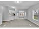 Spacious living room featuring neutral paint, carpet, and seamless transition to kitchen and dining areas at 2305 S Rybolt Ave, Indianapolis, IN 46241