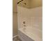 A bathroom showing a clean white bathtub with a shower head, complemented by tiled walls and simple fixtures at 2610 Big Bear Ln, Indianapolis, IN 46217