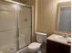 Cozy bathroom featuring a frosted glass shower, standard toilet, and vanity with neutral countertop at 2610 Big Bear Ln, Indianapolis, IN 46217