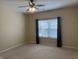 Bedroom with neutral carpet, ceiling fan, and a window with curtains at 2610 Big Bear Ln, Indianapolis, IN 46217