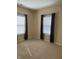 Neutral bedroom with two windows, carpeted floor, and warm-toned walls, bathed in natural light at 2610 Big Bear Ln, Indianapolis, IN 46217