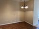 Open dining room with wood flooring and a modern chandelier at 2610 Big Bear Ln, Indianapolis, IN 46217