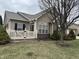 Charming home featuring a white picket fence, brick accents, tidy landscaping, and a well-maintained lawn at 2610 Big Bear Ln, Indianapolis, IN 46217