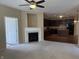Open living space with fireplace flows into kitchen with dark cabinets and island at 2610 Big Bear Ln, Indianapolis, IN 46217
