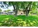 Spacious backyard featuring mature trees, playset, trampoline and a small patio at 2700 Yellowwood Ct, Columbus, IN 47203